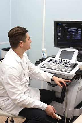 Clinician reviewing diagnostic imaging on a monitor
