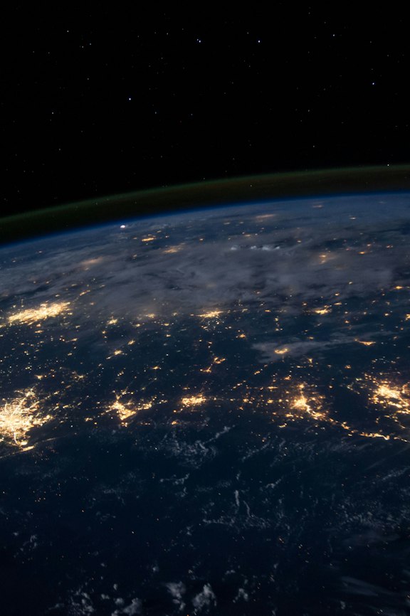 Earth at night from space, showing interconnected city lights